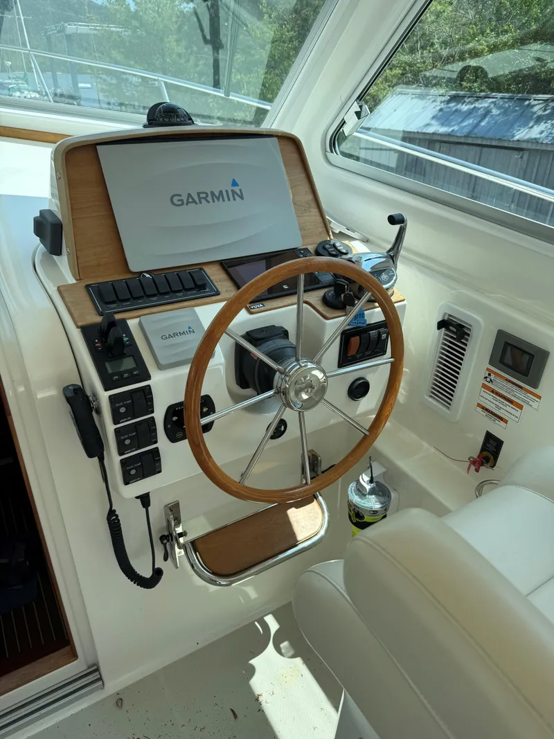 Slide: The Image of 2019 Back Cove Downeast helm with Garmin navigation system and wooden steering wheel. - 31