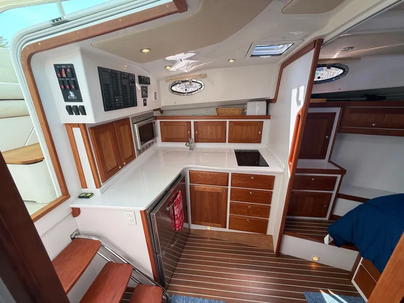 Slide: The Image of 2019 Back Cove Downeast yacht interior with wooden cabinetry and modern kitchen amenities. - 35