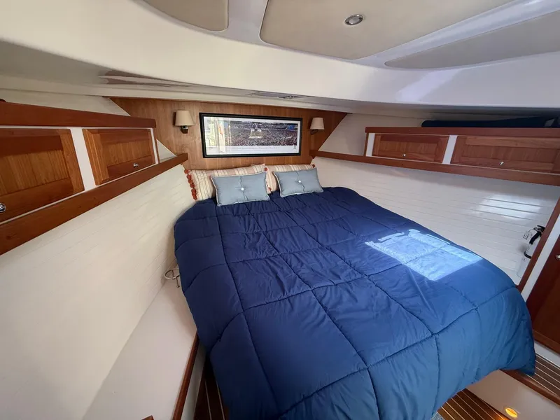 Slide: The Image of 2019 Back Cove Downeast cabin with cozy bed, wooden accents, and nautical decor. - 41