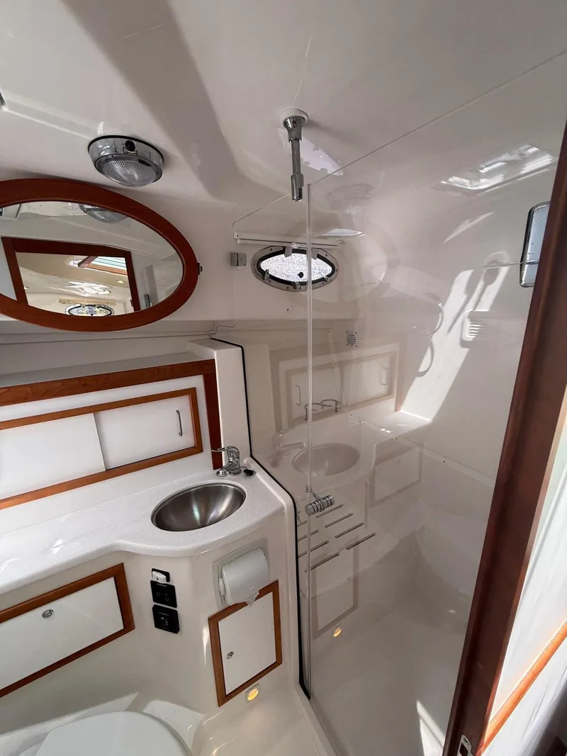 Slide: The Image of 2019 Back Cove Downeast boat bathroom with sink, shower, and mirror. - 44