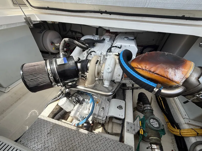 Slide: The Image of Engine compartment of a 2019 Back Cove Downeast boat, showcasing mechanical components. - 46