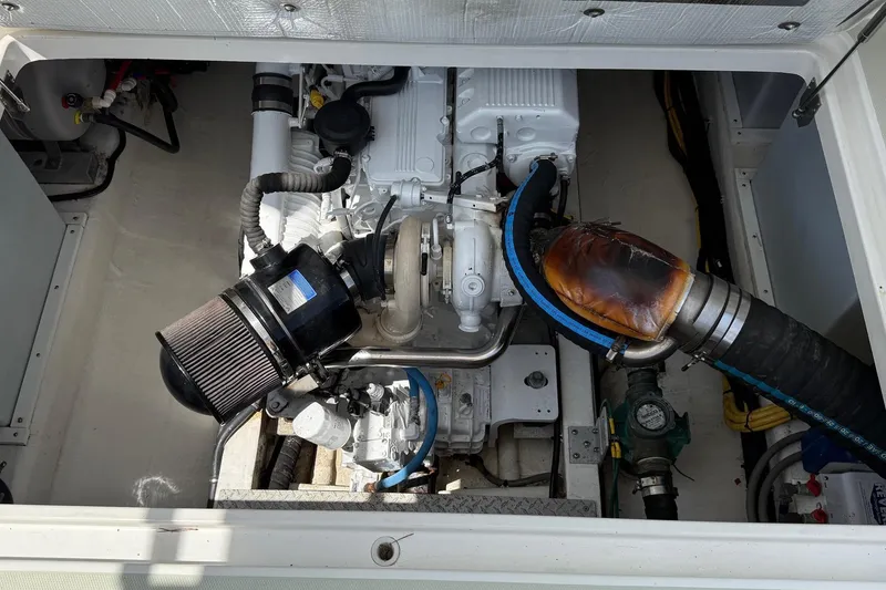 Slide: The Image of Engine compartment of a 2019 Back Cove Downeast boat, showcasing mechanical components. - 47