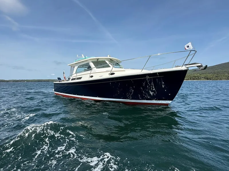 Slide: The Image of 2019 Back Cove Downeast boat cruising on open water under clear skies. - 5