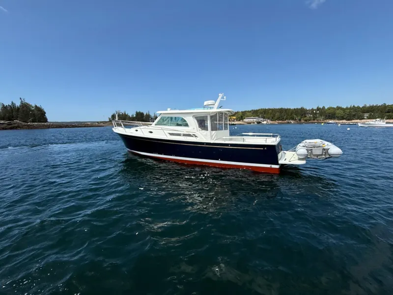 Slide: The Image of 2019 Back Cove Downeast boat on calm water under clear blue sky. - 8