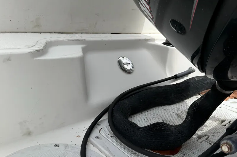 Slide: The Image of 1998 Boston Whaler 23 Conquest boat engine area with visible cables and fittings. - 15