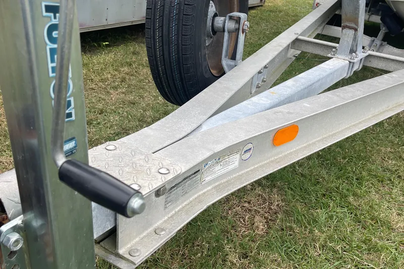 Slide: The Image of Trailer hitch and wheel for 1998 Boston Whaler 23 Conquest on grass. - 18