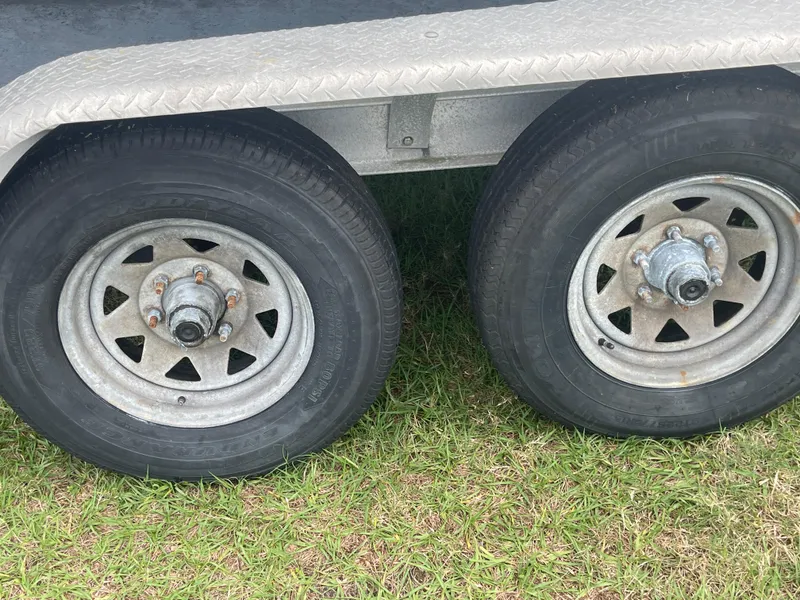 Slide: The Image of Trailer wheels for 1998 Boston Whaler 23 Conquest on grass. - 20