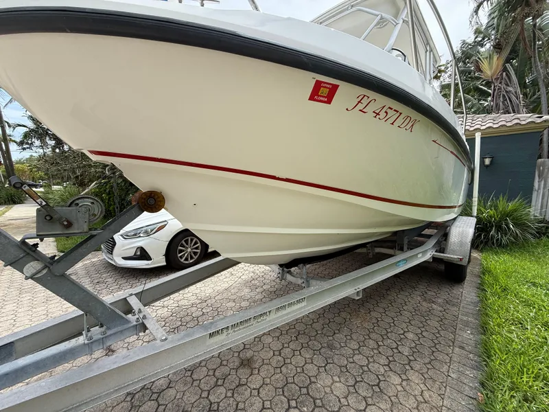 Slide: The Image of 1998 Boston Whaler 23 Conquest boat on trailer, parked in driveway. - 3