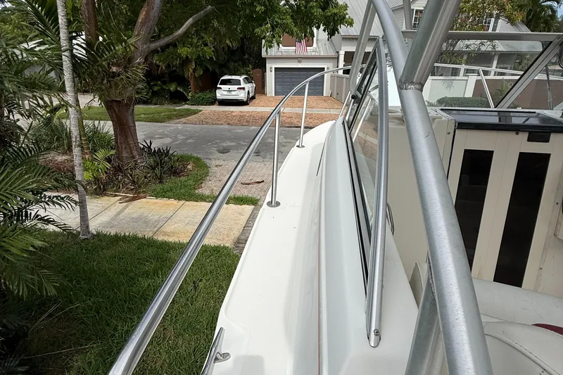 Slide: The Image of 1998 Boston Whaler 23 Conquest boat parked in a residential driveway. - 7
