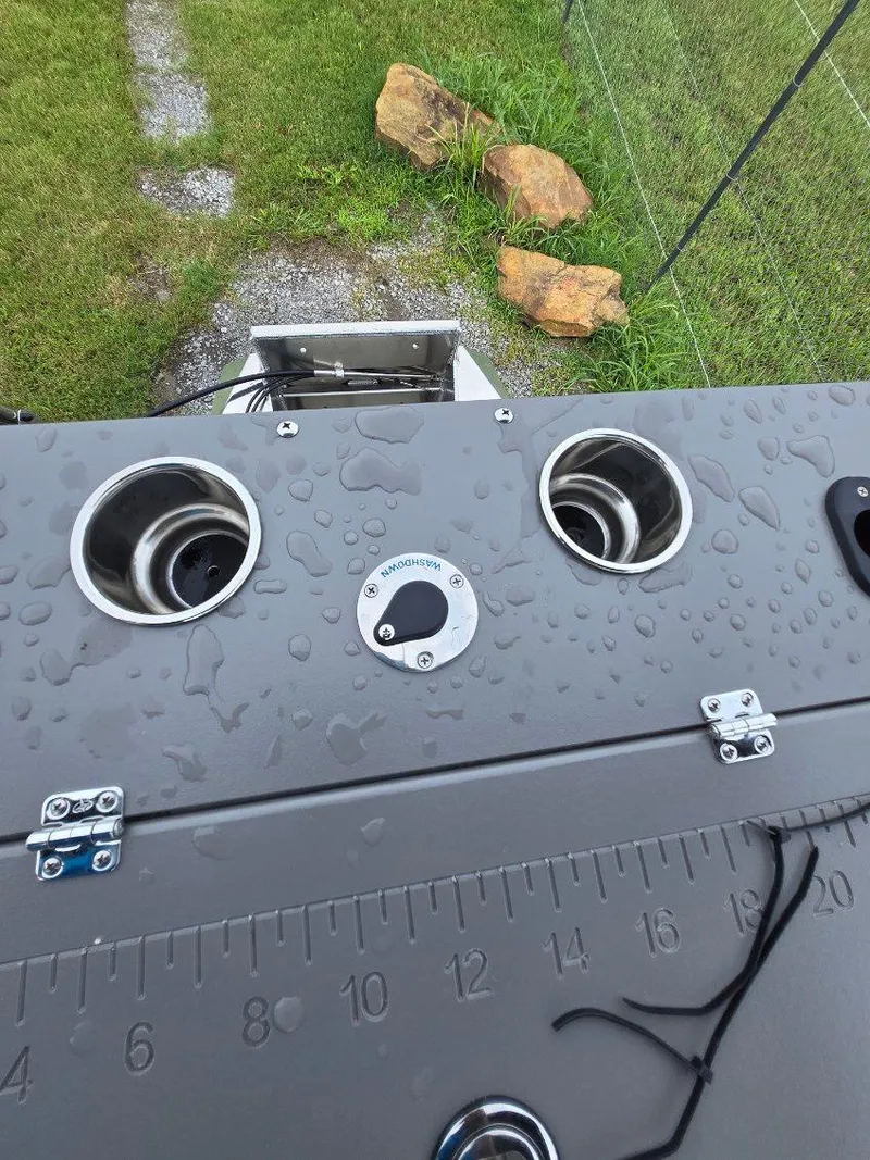 Slide: The Image of 2025 Qwest 20 XRE FISH boat deck with rod holders and measurement ruler. - 12