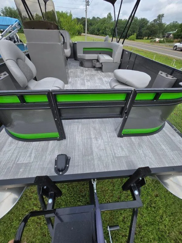 Slide: The Image of 2025 Qwest 20 XRE FISH pontoon boat with green accents and spacious seating. - 4