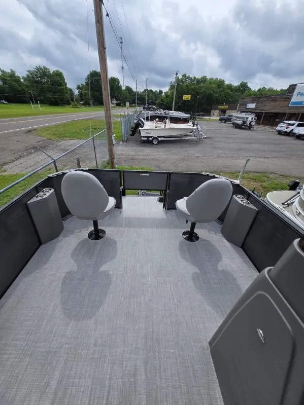 Slide: The Image of 2025 Qwest 20 XRE FISH boat with two seats, outdoor dealership setting. - 6