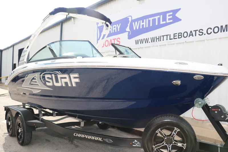 Slide: The Image of 2025 Chaparral 21 Surf boat on trailer, displayed at dealership. - 10