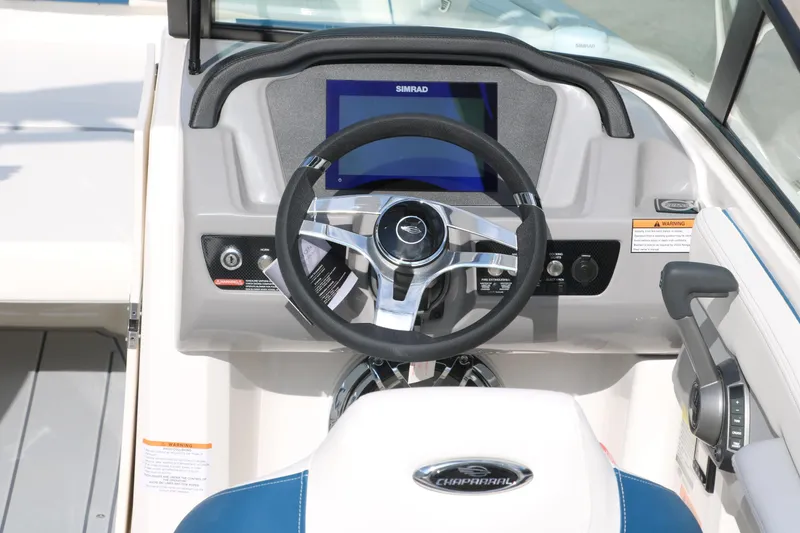 Slide: The Image of 2025 Chaparral 21 Surf boat dashboard with steering wheel and digital display. - 15
