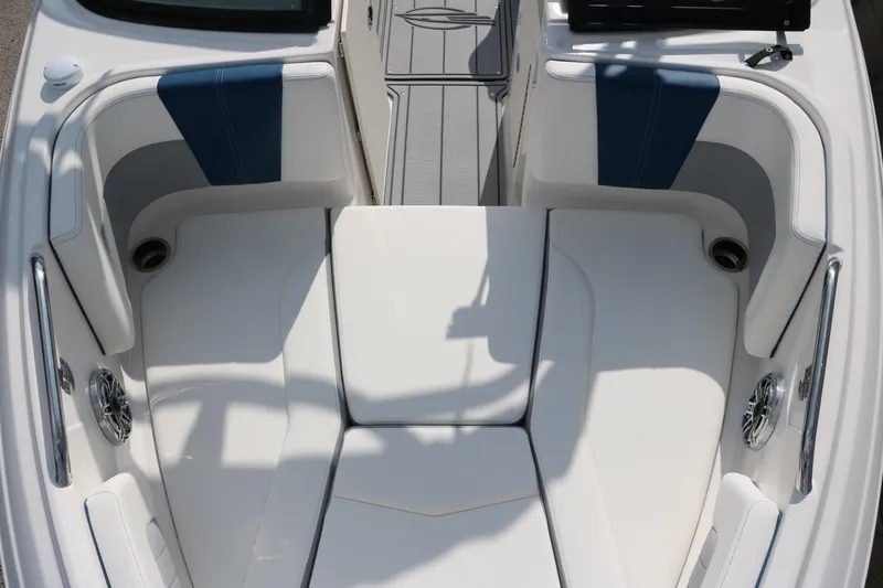 Slide: The Image of 2025 Chaparral 21 Surf boat interior with white and blue seating. - 17