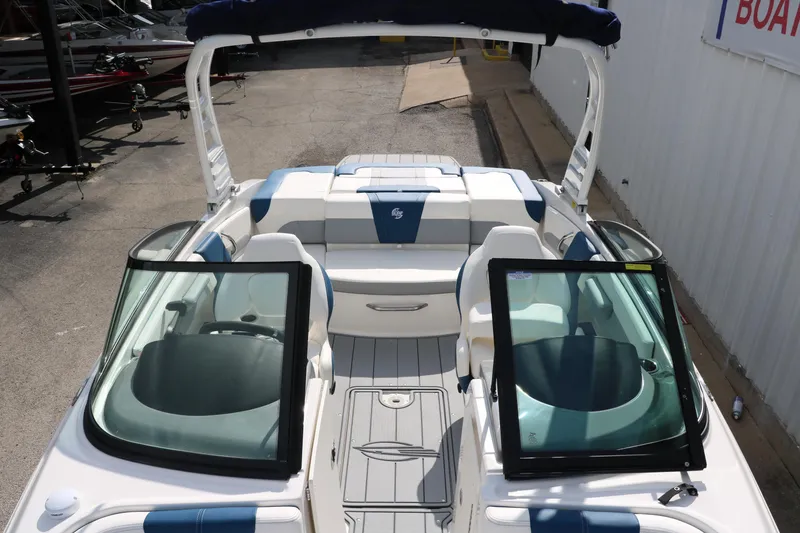 Slide: The Image of 2025 Chaparral 21 Surf boat interior with open windshield and seating. - 19
