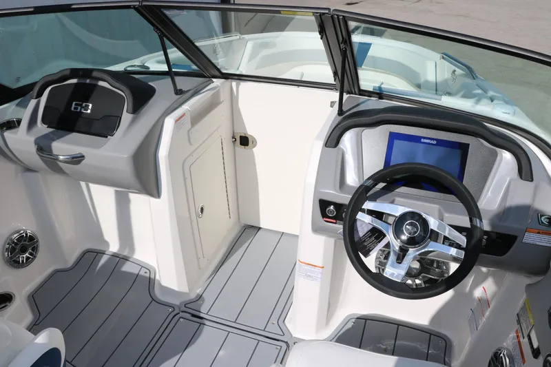 Slide: The Image of 2025 Chaparral 21 Surf boat interior with modern dashboard and steering wheel. - 21