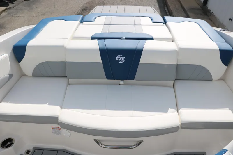 Slide: The Image of 2025 Chaparral 21 Surf boat with stylish blue and white seating. - 23