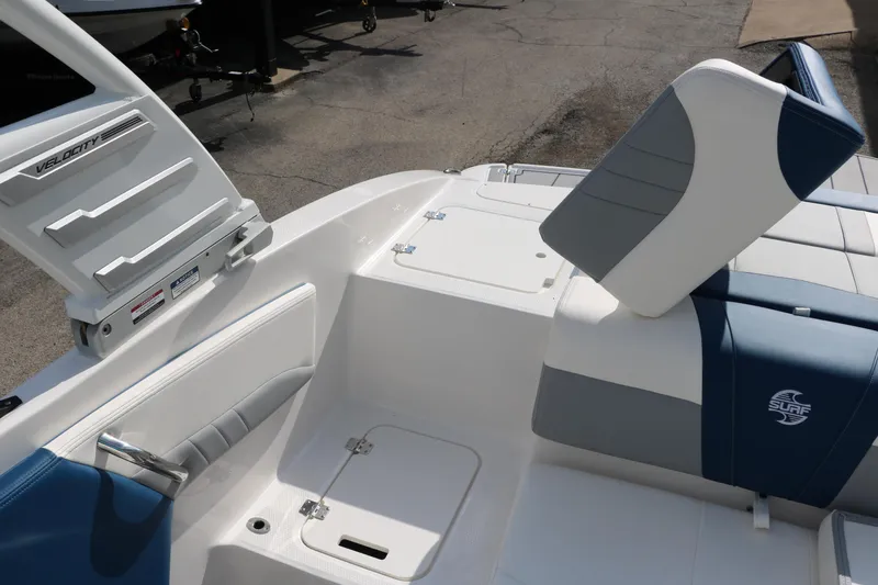 Slide: The Image of 2025 Chaparral 21 Surf boat interior with blue and white seating and storage compartments. - 27