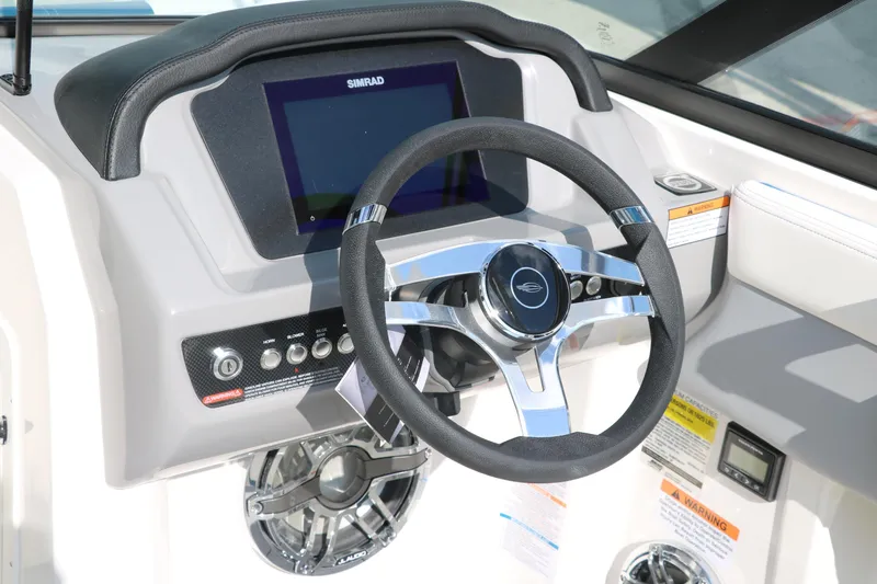 Slide: The Image of 2025 Chaparral 21 Surf boat dashboard with steering wheel and digital display. - 28