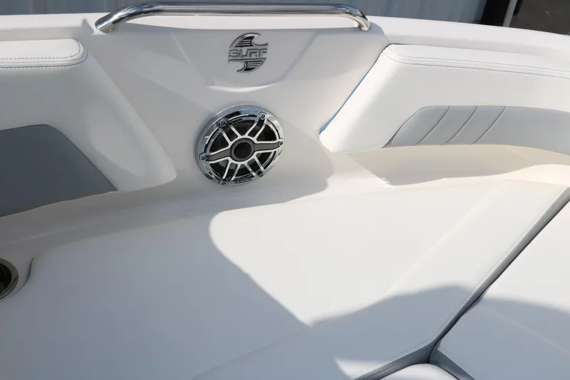 Slide: The Image of Interior of 2025 Chaparral 21 Surf boat with speaker and cushioned seating. - 29