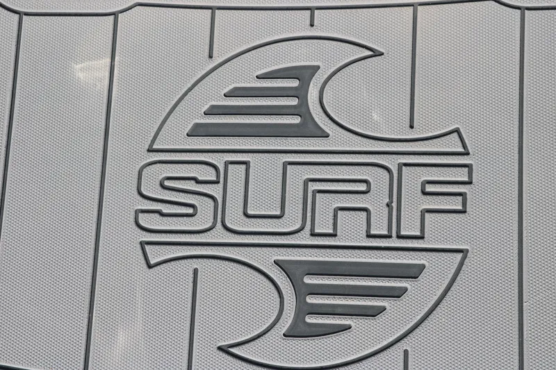 Slide: The Image of Chaparral 21 Surf 2025 logo on textured surface, featuring stylized wave design. - 31