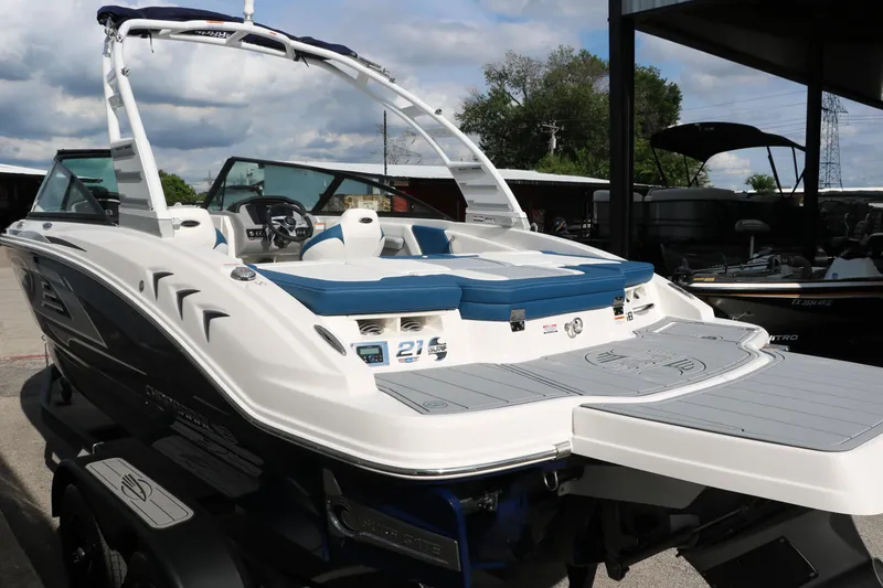 Slide: The Image of 2025 Chaparral 21 Surf boat with sleek design and spacious deck. - 6