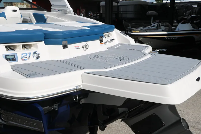 Slide: The Image of 2025 Chaparral 21 Surf boat, rear view with swim platform and seating. - 7