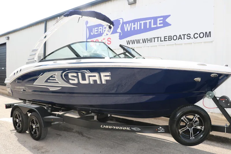 Slide: The Image of 2025 Chaparral 21 Surf boat on trailer, displayed at dealership. - 9