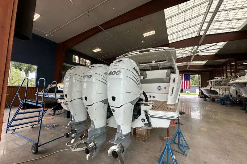 Slide: The Image of 2022 Tiara Yachts 38 LX with triple Mercury 400 engines in a showroom. - 16