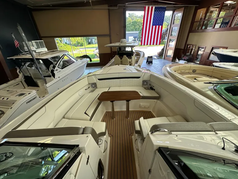Slide: The Image of 2022 Tiara Yachts 38 LX in showroom, featuring elegant interior and American flag display. - 18