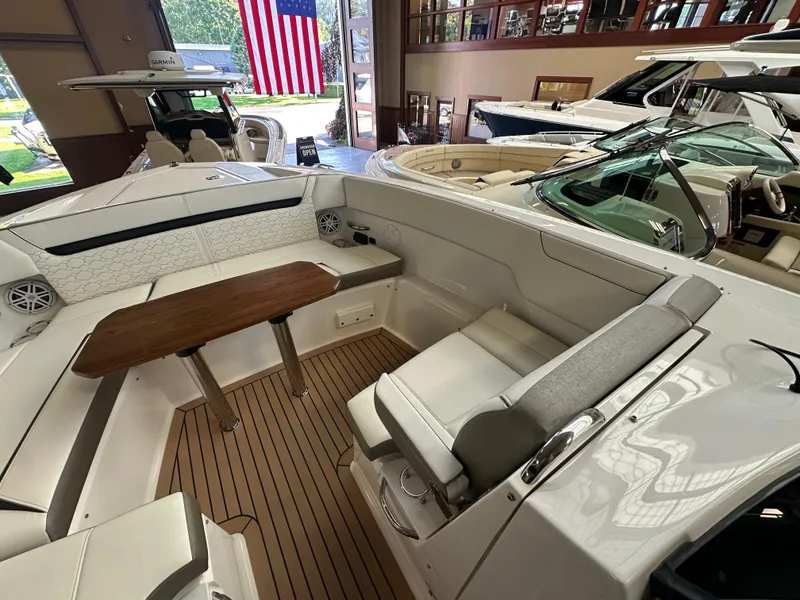 Slide: The Image of 2022 Tiara Yachts 38 LX interior with seating and wooden table, displayed indoors. - 20