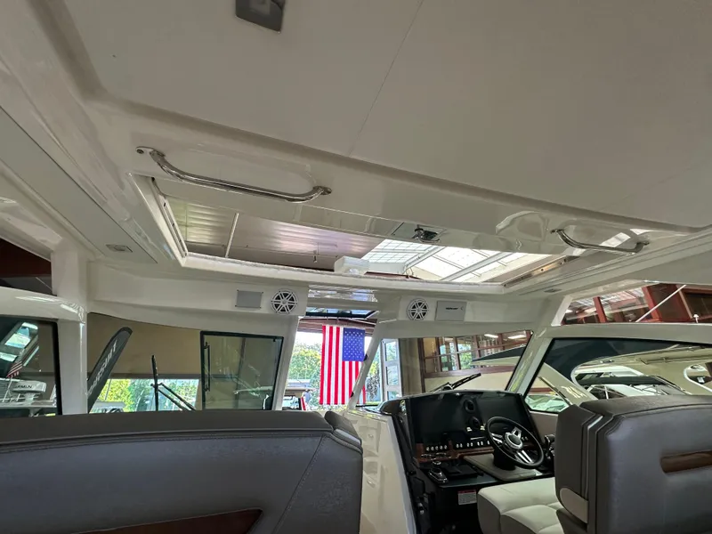 Slide: The Image of Interior view of 2022 Tiara Yachts 38 LX, showcasing helm and seating area. - 26