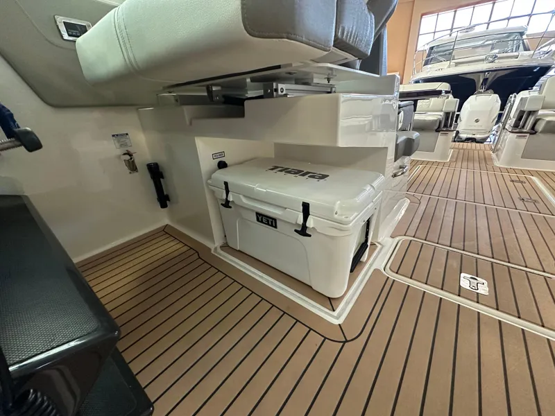 Slide: The Image of 2022 Tiara Yachts 38 LX interior with Yeti cooler and teak flooring. - 29