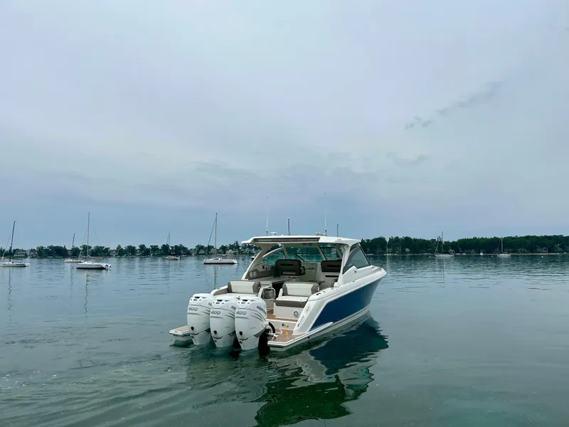 Slide: The Image of 2022 Tiara Yachts 38 LX on calm water with triple outboard engines. - 3