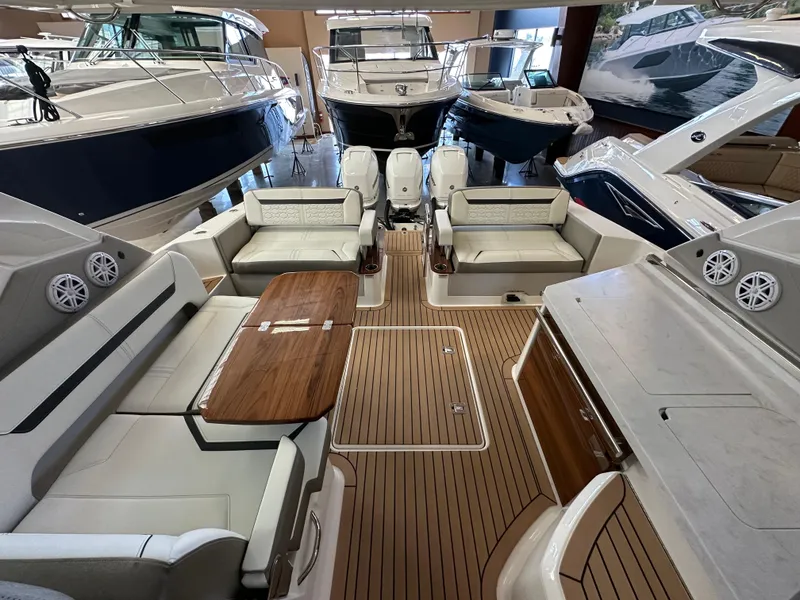 Slide: The Image of 2022 Tiara Yachts 38 LX interior with seating, table, and modern design in showroom. - 30
