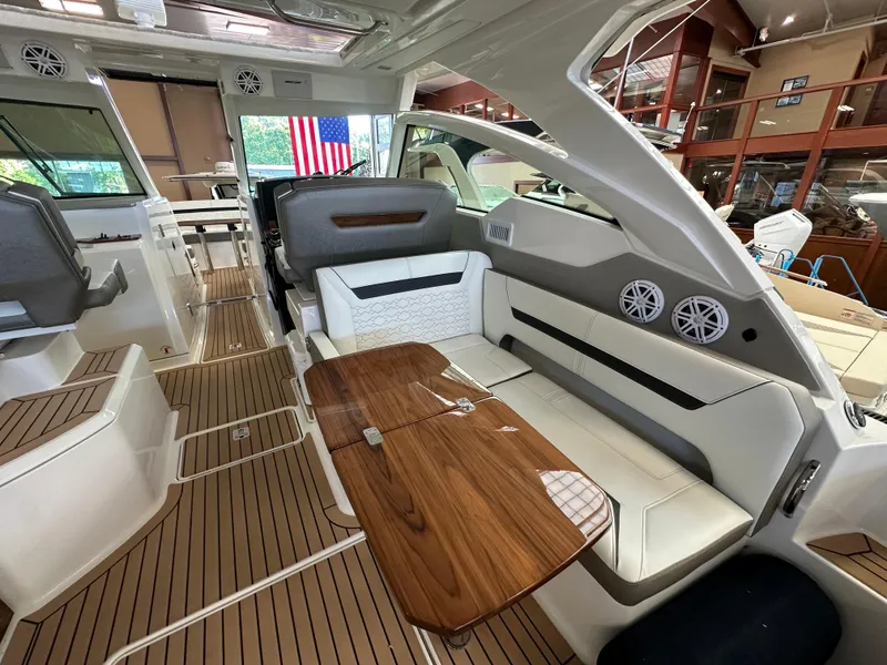 Slide: The Image of 2022 Tiara Yachts 38 LX interior with elegant seating and wooden table. - 31