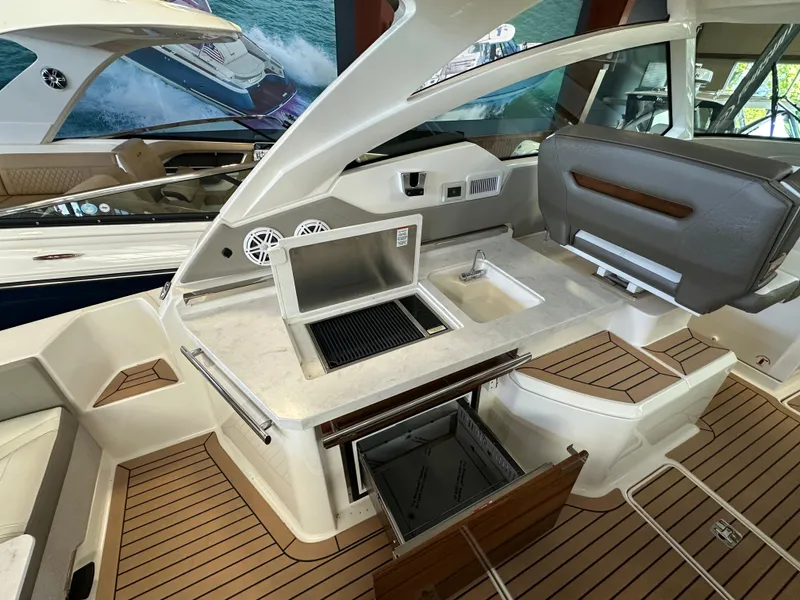Slide: The Image of 2022 Tiara Yachts 38 LX interior with kitchenette, featuring grill and sink. - 33
