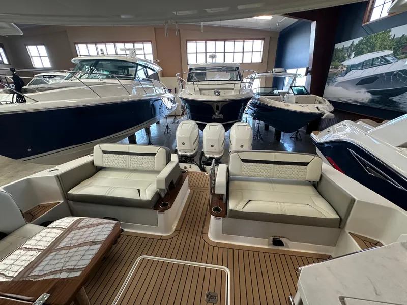 Slide: The Image of 2022 Tiara Yachts 38 LX interior with luxurious seating and modern design in showroom. - 34