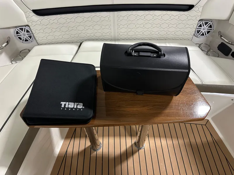 Slide: The Image of Tiara Yachts 38 LX 2022 interior with table, black case, and branded folder. - 39