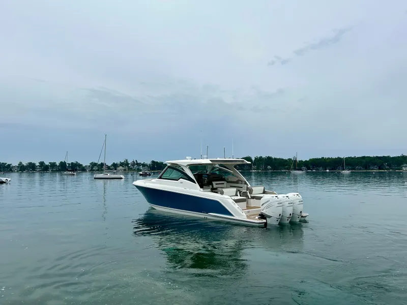 Slide: The Image of 2022 Tiara Yachts 38 LX on calm water, showcasing sleek design and powerful engines. - 7