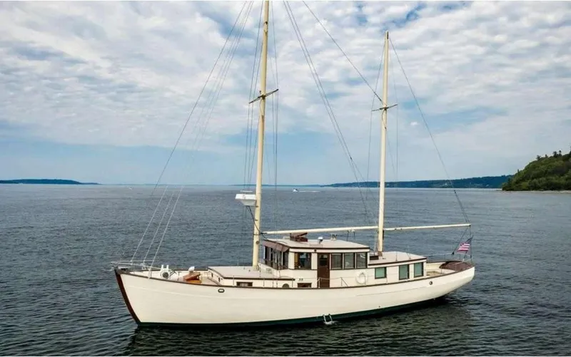 The Image of Classic 1936 Motorsailer on calm waters under a partly cloudy sky. - 0