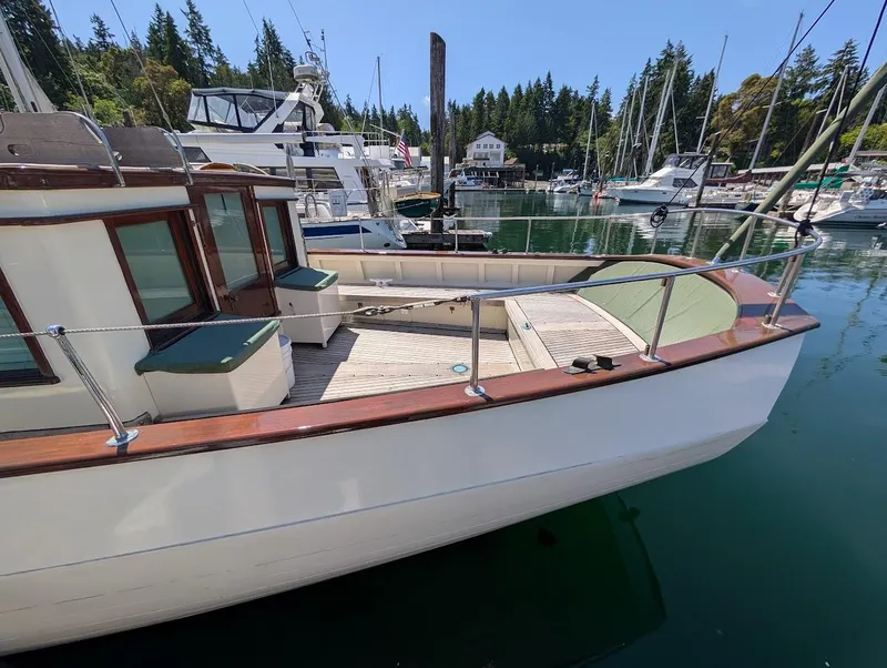 Slide: The Image of Classic 1936 Motorsailer docked in a serene marina setting. - 14