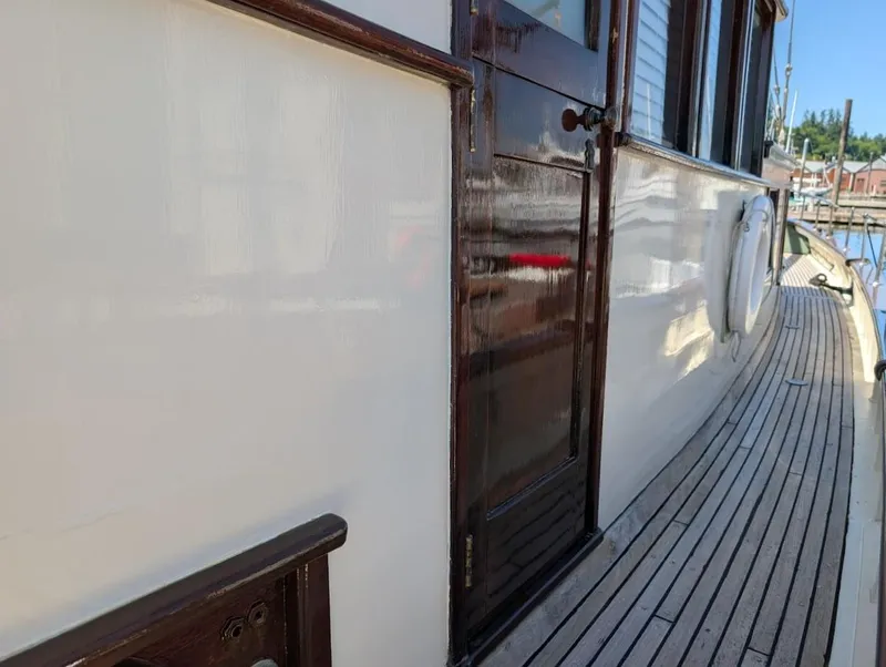 Slide: The Image of Classic 1936 Motorsailer with wooden deck and polished cabin door. - 15