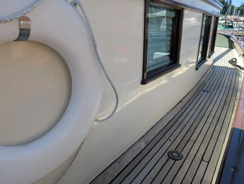 Slide: The Image of Classic 1936 Motorsailer with wooden deck and life preserver, showcasing vintage nautical design. - 16