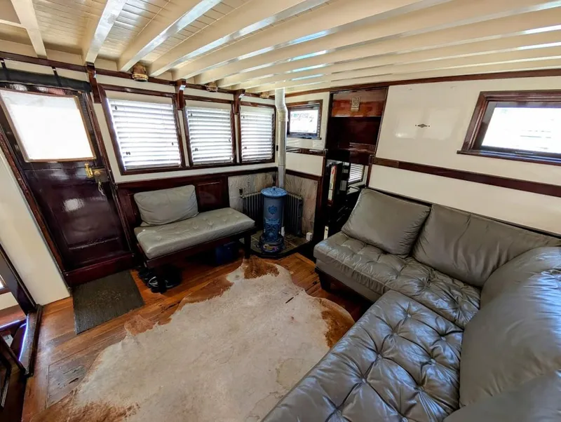 Slide: The Image of Classic 1936 Motorsailer interior with leather seating, wood accents, and nautical decor. - 19