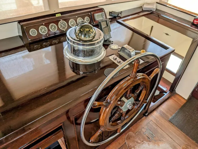 Slide: The Image of Classic 1936 Motorsailer helm with wooden wheel and vintage navigation instruments. - 22