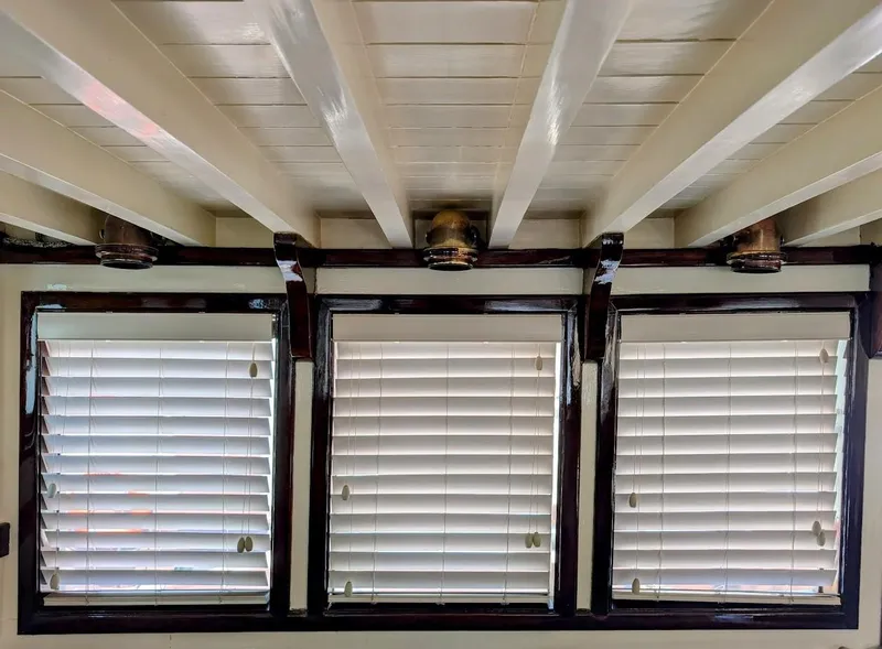 Slide: The Image of Interior view of 1936 Classic Motorsailer with wooden beams and three windows with blinds. - 26