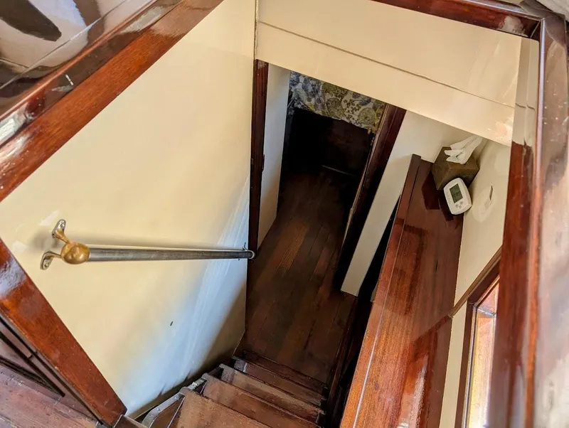 Slide: The Image of Interior view of a 1936 Classic Motorsailer, featuring wooden stairs and polished handrails. - 28