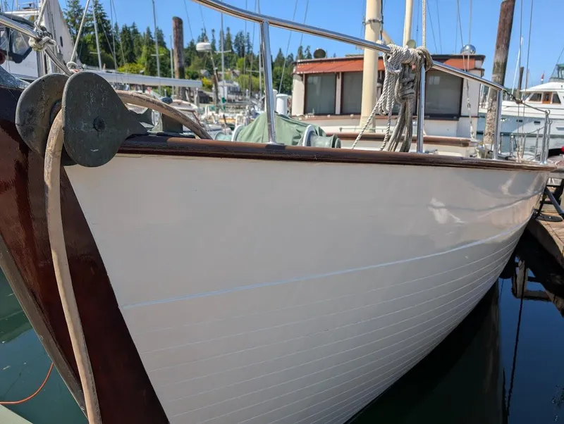 Slide: The Image of Classic 1936 Motorsailer docked at marina, showcasing elegant wooden hull design. - 3